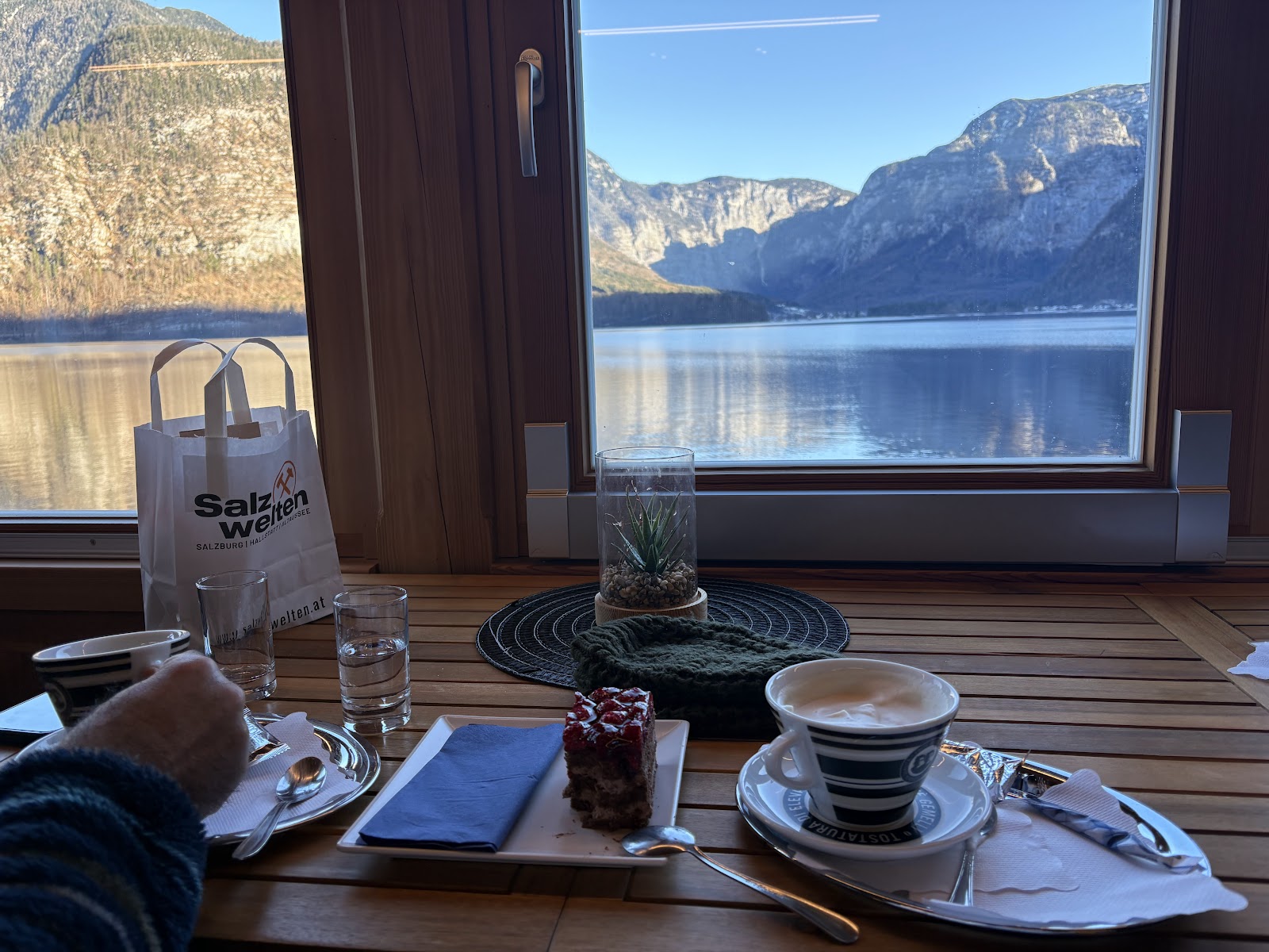 Coffee and cake beside a lake-view window at Tera Hen Cafe